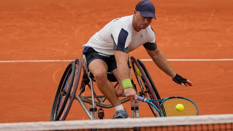 Israel's Adam Berdichevsky returns the ball to Italy's Luca Arca...