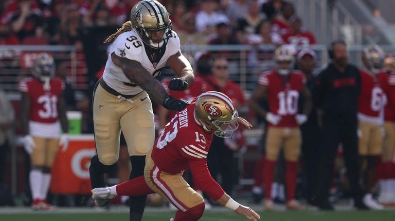 New Orleans Saints defensive end Chase Young (99) knocks San...