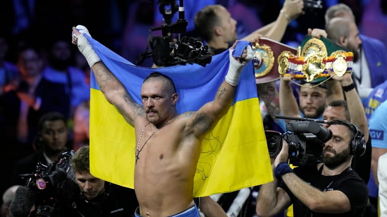 Ukraine's Oleksandr Usyk celebrates after beating Britain's Anthony Joshua to...