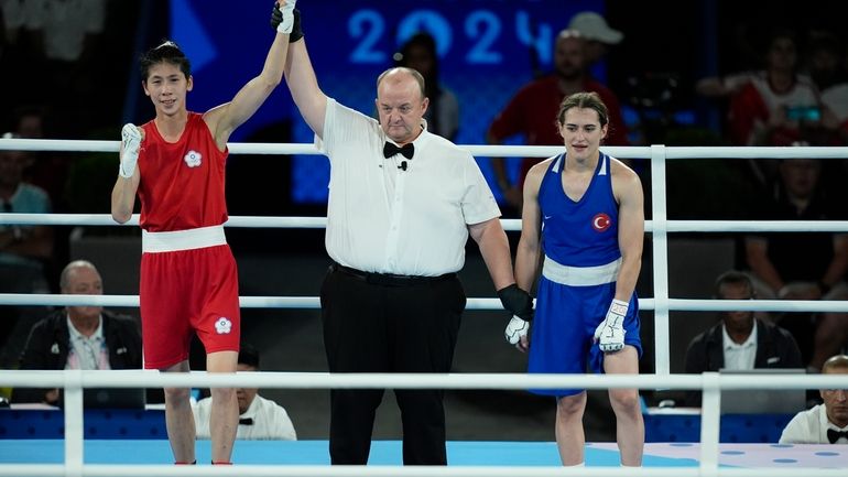 Taiwan's Lin Yu-ting, left, celebrates after defeating Turkey's Esra Yildiz...