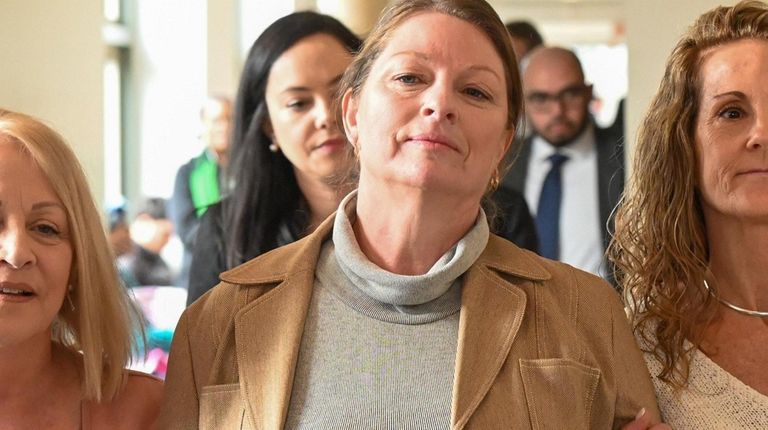 Ann Marie Drago, center, leaves a courtroom in State Supreme Court...