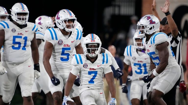 Mississippi safety Louis Moore (7) celebrates with teammates after recovering...