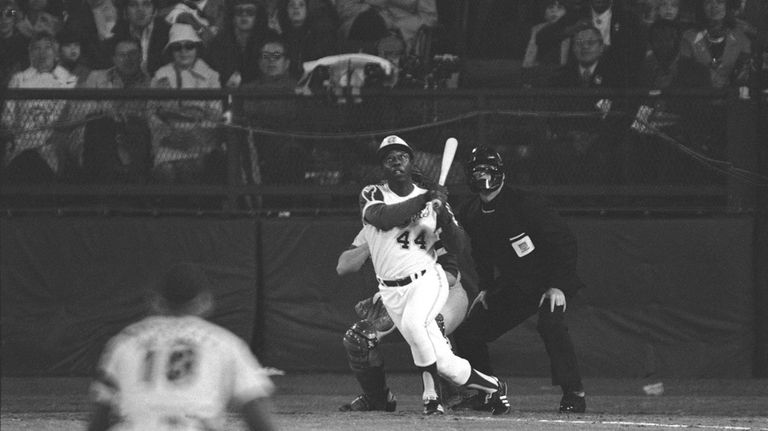 Atlanta Braves' Hank Aaron eyes the flight of the ball...