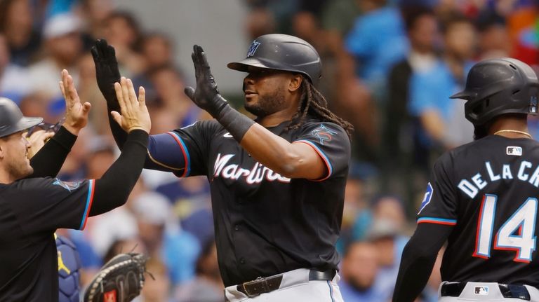 Miami Marlins' Josh Bell, center, is congratulated by Nick Fortes,...