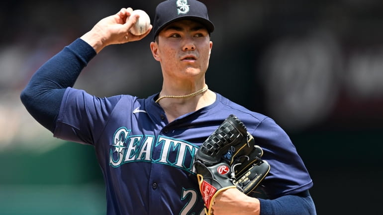 Seattle Mariners starting pitcher Bryan Woo throws during the first...