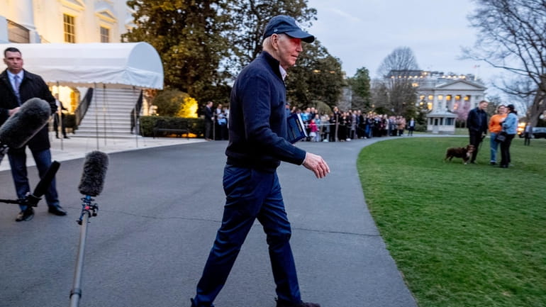 President Joe Biden walks towards Marine One on the South...