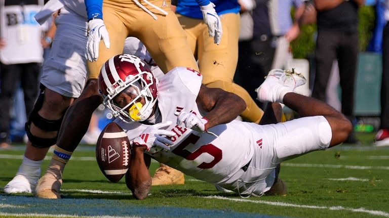 Indiana wide receiver Ke'Shawn Williams, right, loses control of the...