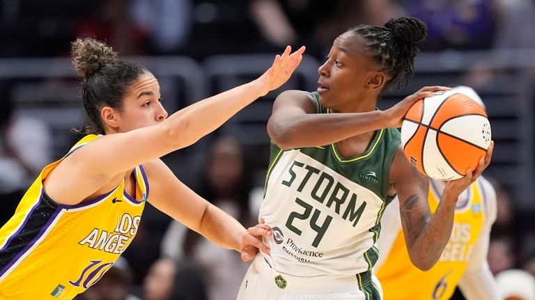 Seattle Storm guard Jewell Loyd, right, tries to pass as...