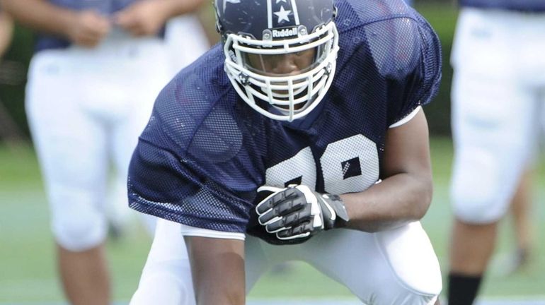 Offensive tackle Malcolm Pridgeon of Central Islip takes part in...