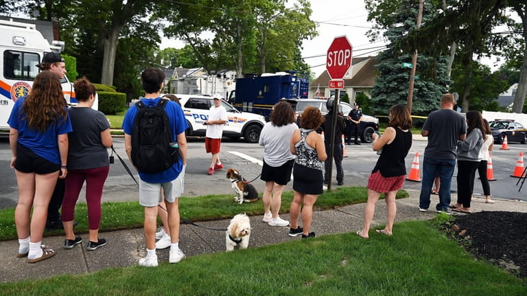 One day after the arrest of Rex Heuermann, onlookers gather on...