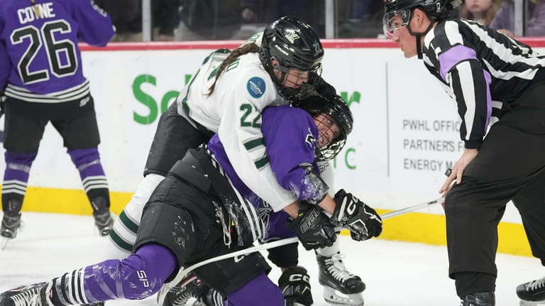Boston's Jessica Digirolamo (22) becomes entangled with Minnesota's Taylor Heise...