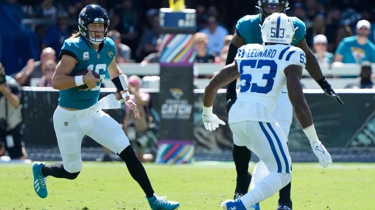 Jacksonville Jaguars quarterback Trevor Lawrence (16) scrambles as Indianapolis Colts...