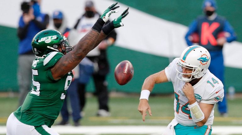 Quinnen Williams, left, knocks down a pass by Miami's Ryan...