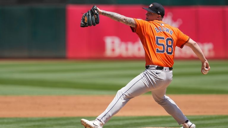 Houston Astros pitcher Hunter Brown throws to an Oakland Athletics...