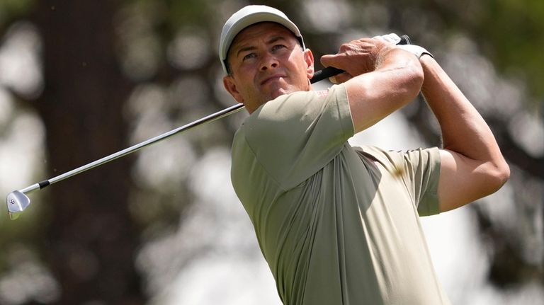 Adam Scott, of Australia, hits from the seventh tee during...