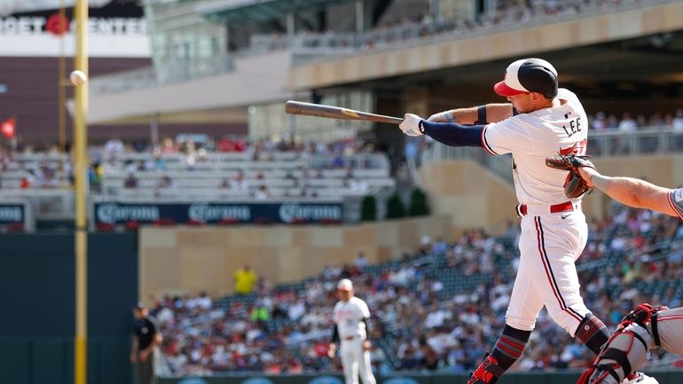 Minnesota Twins' Brooks Lee hits a two-RBI single in the...