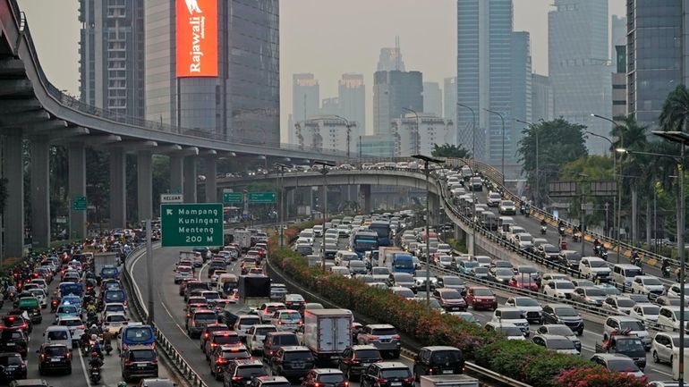 Vehicles are caught in a congestion during rush hour in...