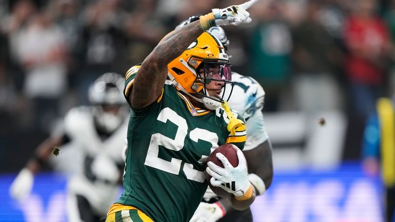 Green Bay Packers cornerback Jaire Alexander (23) celebrates after incepting...