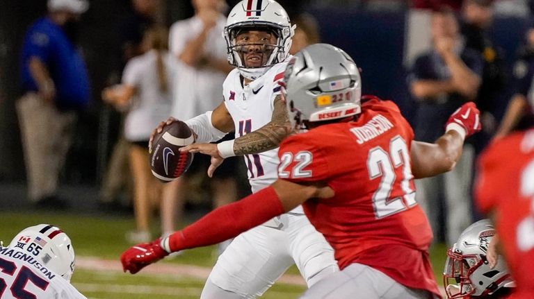 Arizona quarterback Noah Fifita (11) looks to throws against New...