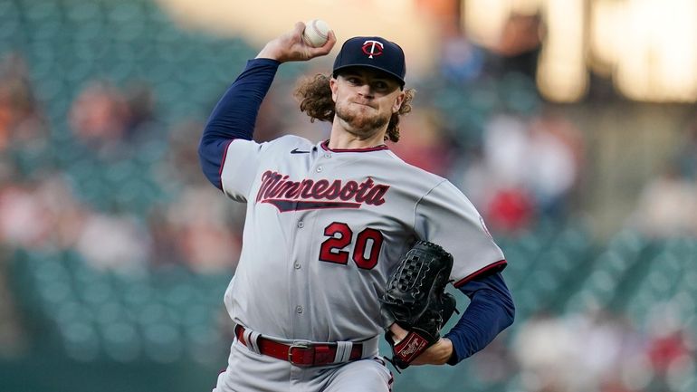 Minnesota Twins starting pitcher Chris Paddack throws a pitch to...