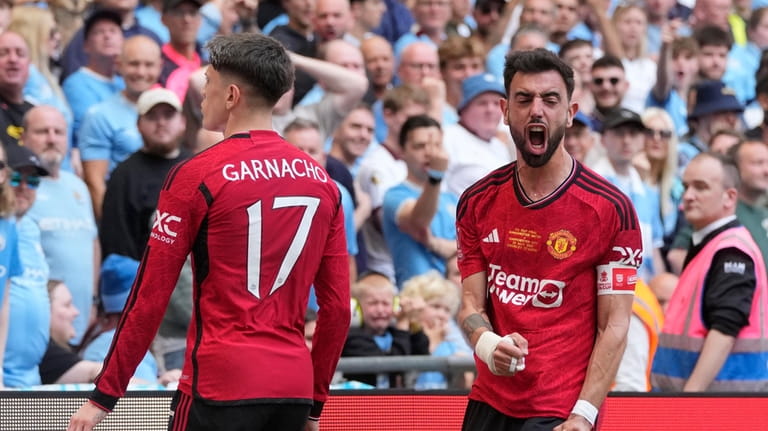 Manchester United's Alejandro Garnacho, left, celebrates after scoring his side's...