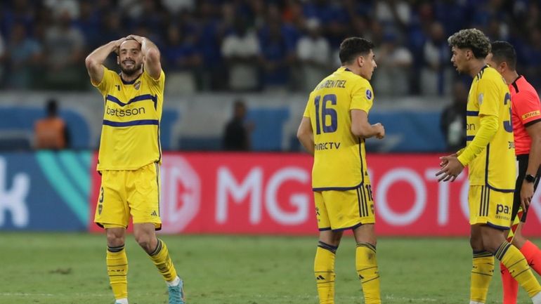 Players of Argentina's Boca Juniors react after losing against Brazil's...