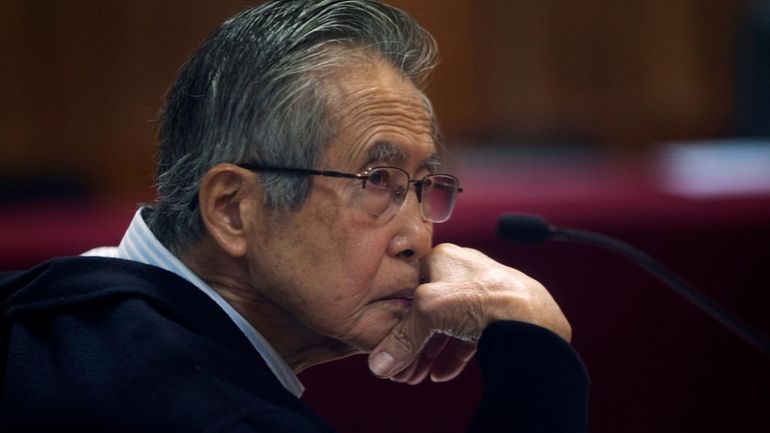 Peru's jailed, former President Alberto Fujimori, photographed through a glass...