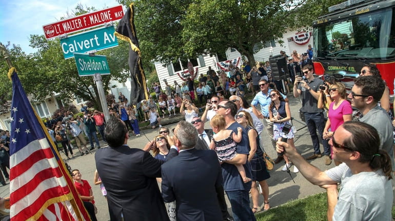 Family, friends, neighbors and public officials gathered at Calvert Avenue and...