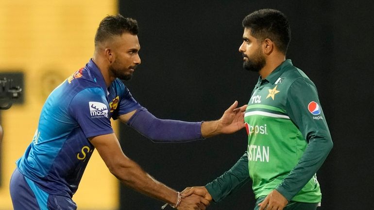 Sri Lankan captain Dasun Shanaka shakes hands with Pakistan's captain...