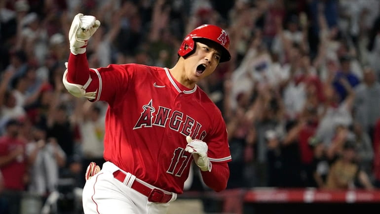 Los Angeles Angels' Shohei Ohtani celebrates as he rounds first...