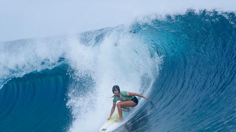 Luana Silva, of Brazil, surfs during the first round of...