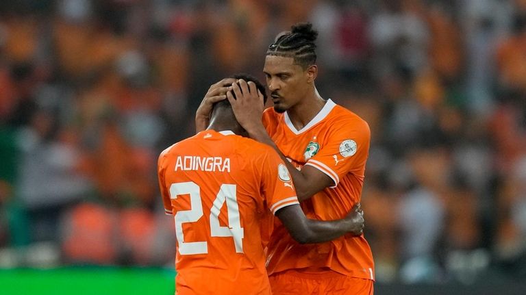 Ivory Coast 's Sebastien Haller, right, celebrates with Ivory Coast...