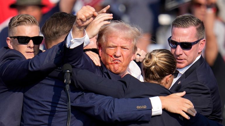 Republican presidential candidate former President Donald Trump pumps his fist...