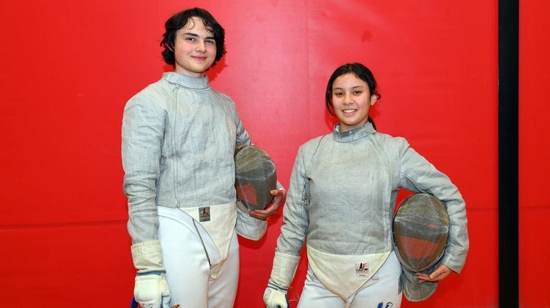 Jukub Pienkowski and Mary Getzoni pose during fencing practice at...