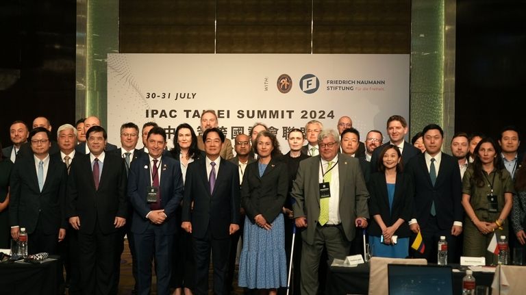 Taiwanese President Lai Ching-te, center left, poses for photos at...