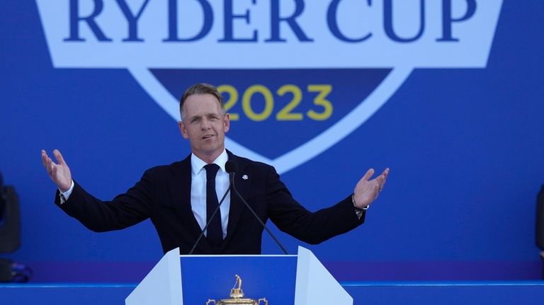 Europe's Team Captain Luke Donald gestures as he speaks onstage...