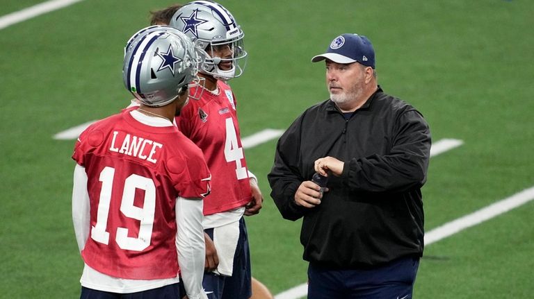 Dallas Cowboys quarterbacks Trey Lance (19) and Dak Prescott (4)...