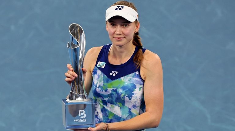 Elena Rybakina of Kazakhstan poses with the trophy after she...