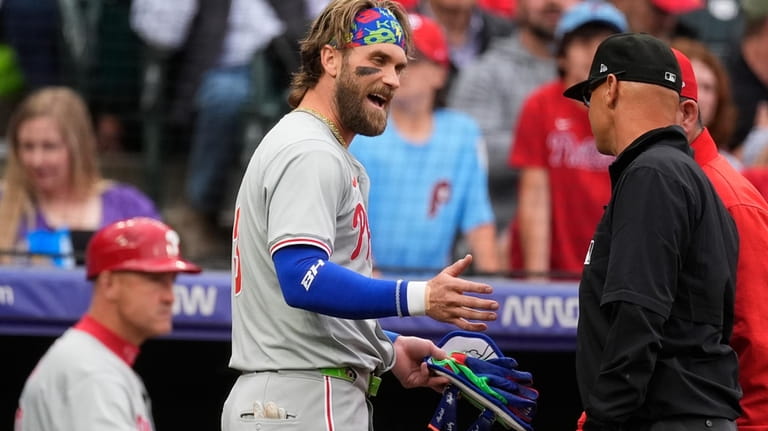 Philadelphia Phillies' Bryce Harper argues with second base umpire Vic...