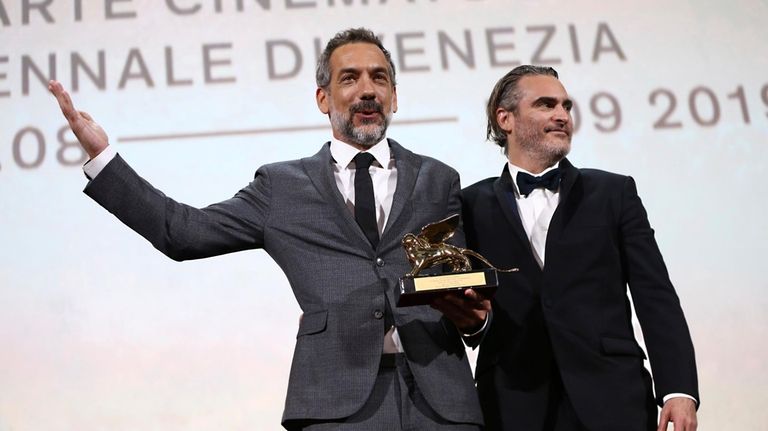 Director Todd Phillips, left, holds the Golden Lion for Best...