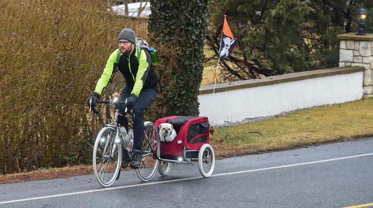 Kevin Motel bicycles to his job at Cycle Fast in Huntington...