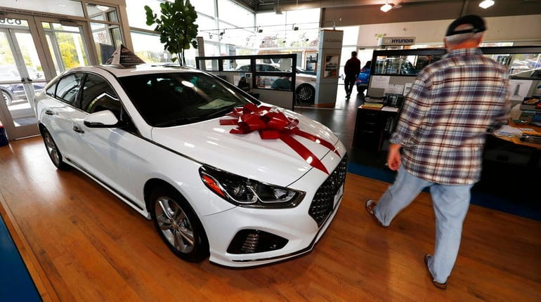 A buyer walks past a 2018 Sonata on the showroom...