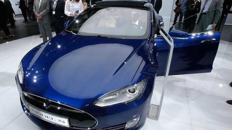 In this Sept. 15, 2015 file photo, a Tesla Model...