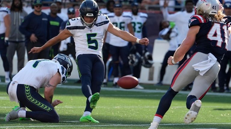 Seattle Seahawks place-kicker Jason Myers, center, boots the winning field...