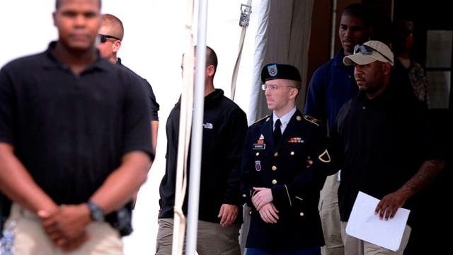 Bradley Manning is escorted out of the courthouse after being...