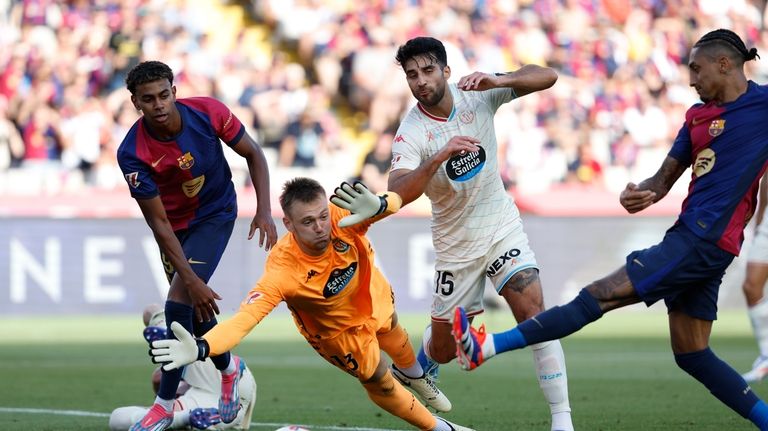 Valladolid's goalkeeper Karl Hein, bottom, fails to save a goal...