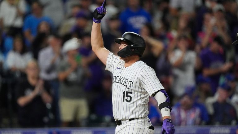 Colorado Rockies' Hunter Goodman gestures as he crosses home plate...