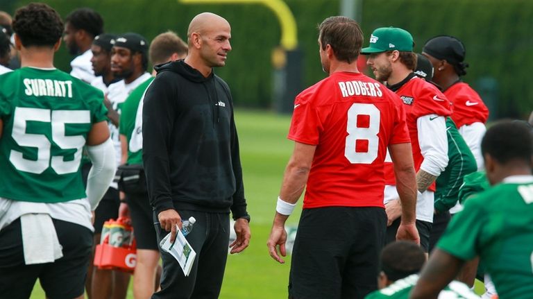 Jets head coach Robert Saleh talks quarterback Aaron Rodgers during training camp...