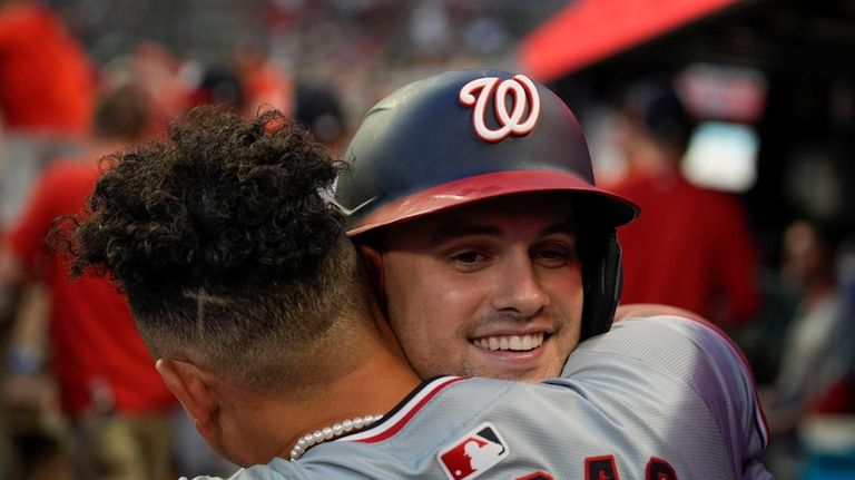 Washington Nationals' Lane Thomas (28) celebrates in the dugout after...