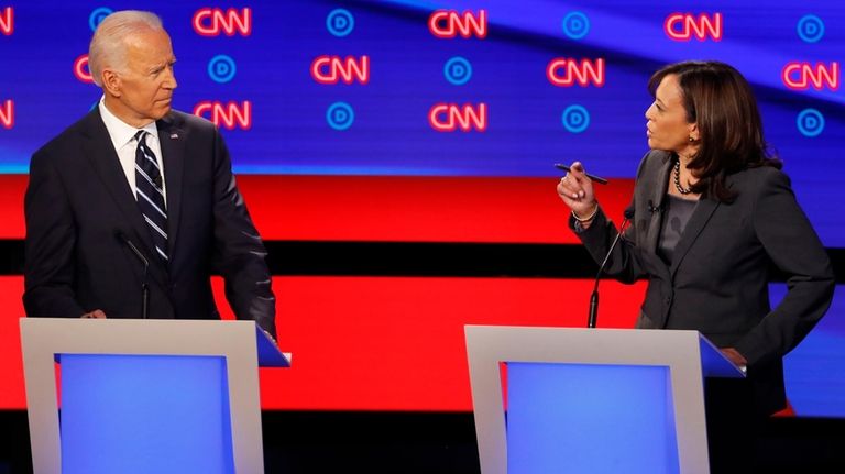 Former Vice President Joe Biden, left, listens as Sen. Kamala...